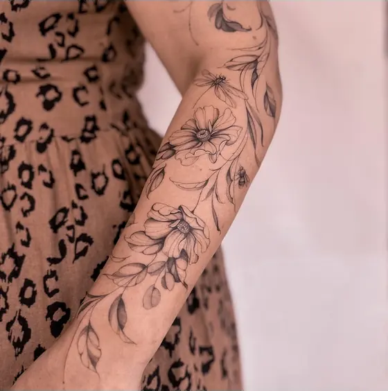 Fine line botanical tattoo on the arm by Ingrid Campelo