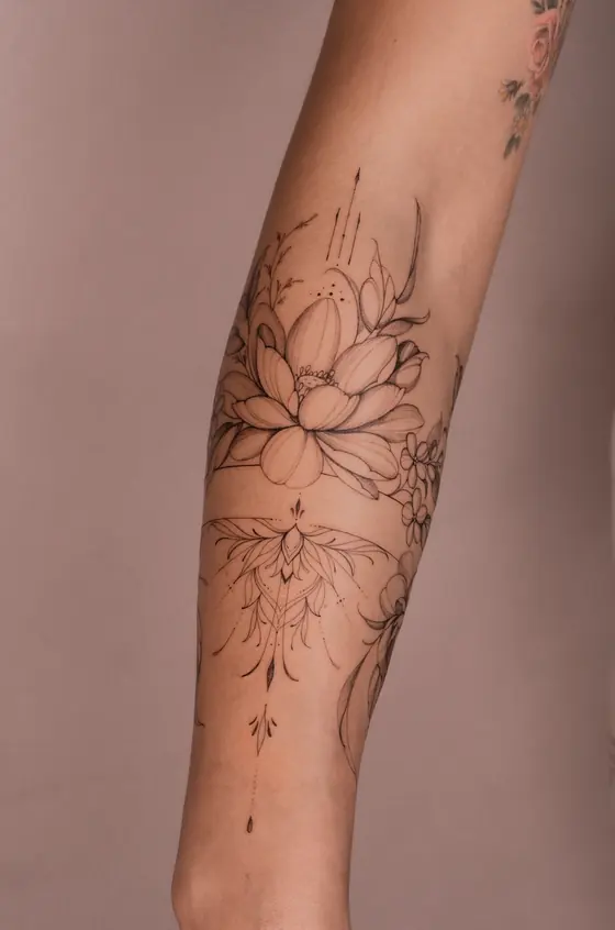 Fine line botanical tattoo on the forearm by Ingrid Campelo