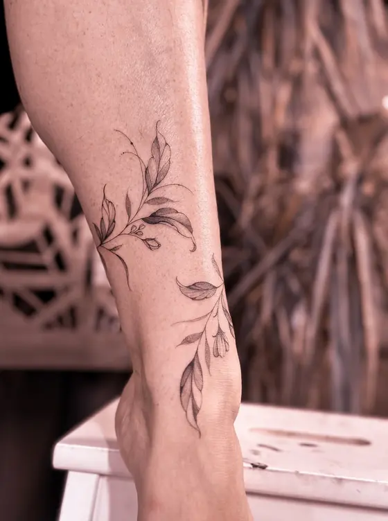 Fine line botanical tattoo on the arm by Ingrid Campelo