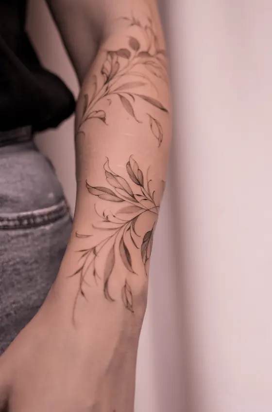 Fine line botanical tattoo on the forearm by Ingrid Campelo